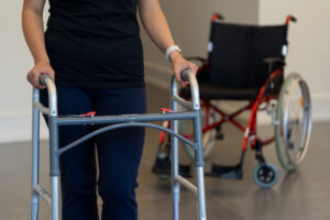 Figure 2. The transition from being in a wheelchair to using a walker is a big step that can be accomplished with work after a surgery. Breaking a bone or surgery can limit your ability to walk, however with proper care and treatment bones can heal and walking can be possible again.