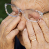 Senior caucasian woman rubbing her eyes under eyeglasses