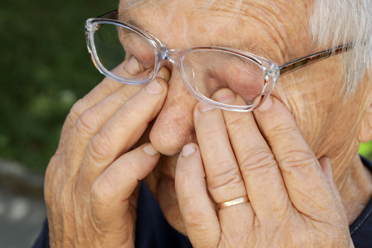 Senior caucasian woman rubbing her eyes under eyeglasses