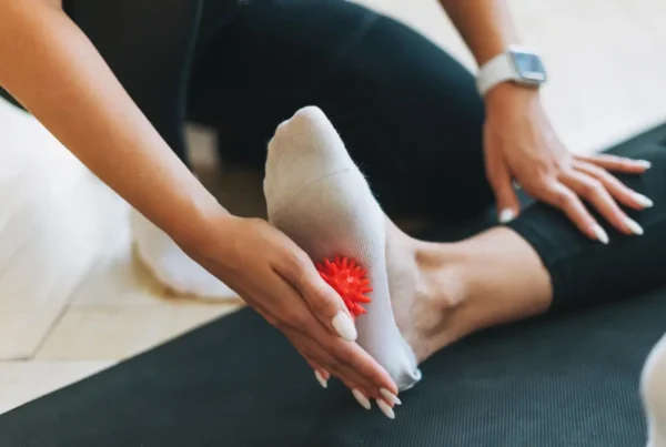 img woman s foot on a mat with massage ball